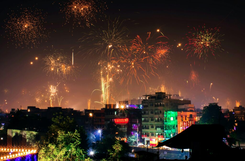 Vibrant fireworks light up the night sky during a festival in an Indian city.